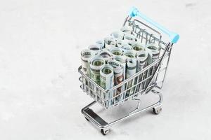 cart with dollar banknotes on concrete board photo