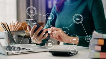 Business hand analyzing sales data and economic growth and pointing at business report document with icon and graph financial, marketing, online banking and payment, at office photo