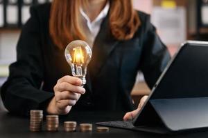 business hand showing creative business strategy with light bulb as concept photo