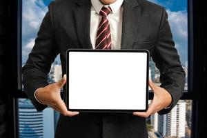 Business man holding and shows touch screen tablet with digital device, technology for smart working photo