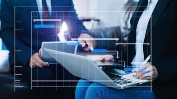 Project manager working and update tasks with milestones progress planning and Gantt chart scheduling diagram. business working with smart phone, tablet and laptop in office. photo