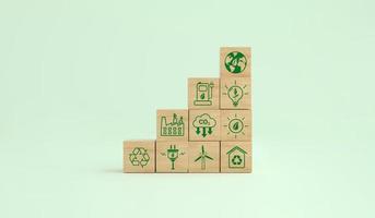 Carbon footprint ecological symbols on a wooden cube. Alternative energies to save the planet. Environmental concept, climate change. photo