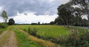 Beautiful high resolution panorama of a northern european country landscape with fields and green grass photo