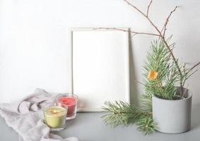 empty frame with copy space. winter still life with glowing candles and pine tree branches in cement flowerpot. place for inspirational text. winter season mood. photo