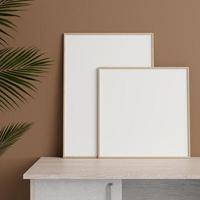 Minimalist front view woodenphoto or poster frame mockup leaning against wall on table with plant. 3d rendering. photo