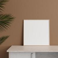 Minimalist front view square wooden photo or poster frame mockup leaning against wall on table with plant. 3d rendering.