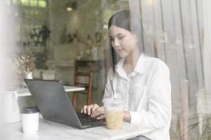 A young woman working with laptop computer in cafe photo