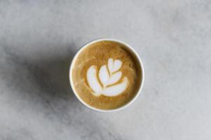 Hot cappuccino or latte art on  white marble  background photo