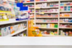 Pharmacy drug store interior blurred background with medicine on shelves photo