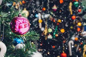 Decorated Christmas tree with colorful bauble on sparkling bokeh light blurred background photo