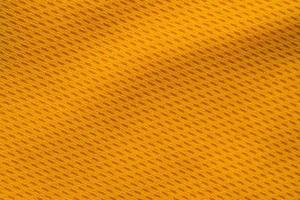 Orange color sports clothing fabric jersey football shirt texture top view photo