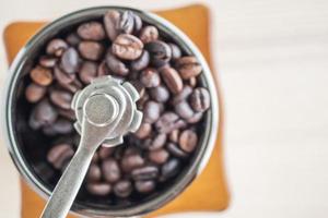 Vintage manual coffee grinder with roasted coffee beans photo