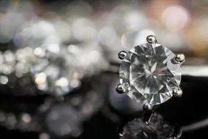 Jewelry wedding diamond rings on black background with reflection photo