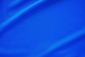 Blue football jersey clothing fabric texture sports wear background, close up top view photo