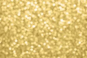 Abstract blur gold glitter sparkle defocused bokeh light background photo