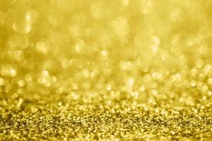 Abstract blur gold glitter sparkle defocused bokeh light background photo