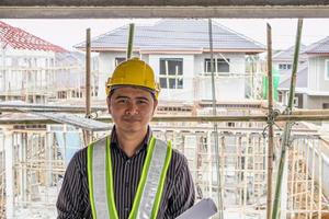 Asian business man construction engineer worker at house building site photo