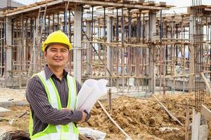 Asian business man construction engineer worker at house building site photo