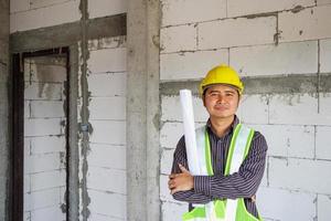 Asian business man construction engineer worker at house building site photo