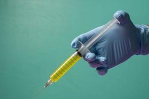 healthcare professional holding a syringe ready to give the injection photo