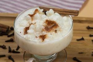 bowl of hominy Canjica on a wooden tray, photo