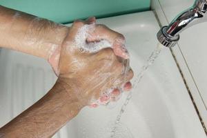 person sanitizing hands photo