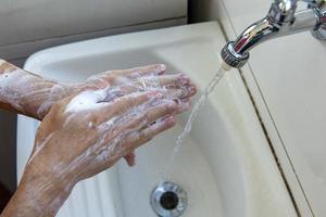 person sanitizing hands photo