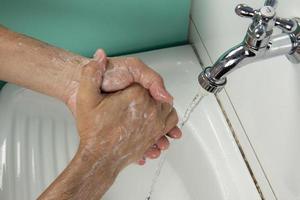 person sanitizing hands photo