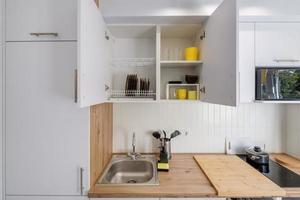 Interior of the modern kitchen in studio apartments in minimalistic style photo