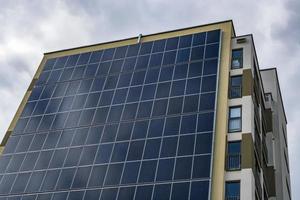 solar panels on the wall of a multi-storey building. Renewable solar energy. photo