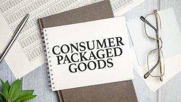 On the table charts, calculator and notebook with the CPG - Consumer Packaged Goods context photo