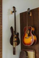Electric and acoustic guitars hanging in room photo