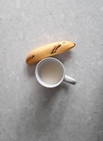 Milk and banana on a marble background for graphic design and wallpaper needs photo