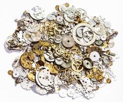 heap of old watch spare parts on white background photo