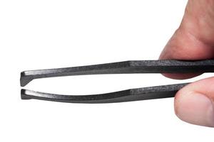 male fingers hold black plastic tweezer photo