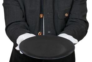 front view of empty black plate in hands in gloves photo