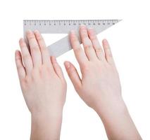 female hands with metallic triangle ruler photo