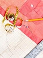 pattern, measuring tape, pencil, pins, red blouse photo