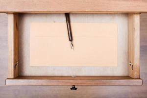 nib pen, paper envelope in open drawer photo