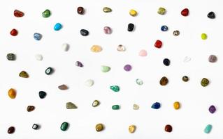 many semi-precious stones arranged on white photo