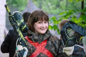 girl in camouflage after paintball game photo