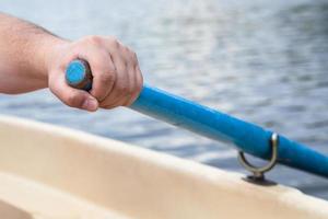 rower's hand holding oar close up photo