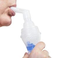 mouthpiece of jet nebulizer in lips of woman photo