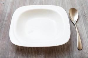 white square bowl and spoon on gray brown table photo