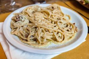 spaghetti ala carbonara on white plate photo