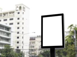 valla publicitaria de poste al aire libre con pantalla blanca simulada en el fondo de la vista de la ciudad y ruta de recorte foto