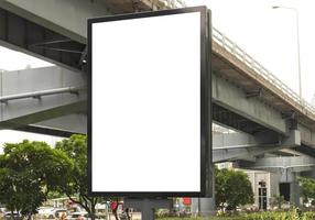 Outdoor pole billboard with mock up white screen on footpath and clipping path photo