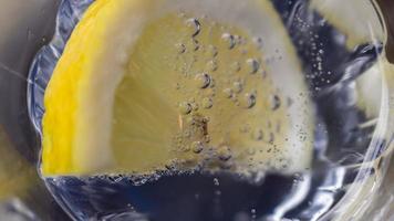 a slice of lemon dipped in sparkling water. close up photo