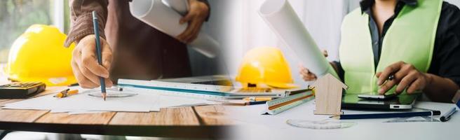 Two colleagues discussing data working and tablet, laptop with on on architectural project at construction site at desk in office photo