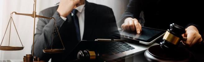 Business and lawyers discussing contract papers with brass scale on desk in office. Law, legal services, advice, justice and law concept picture with film grain effect photo